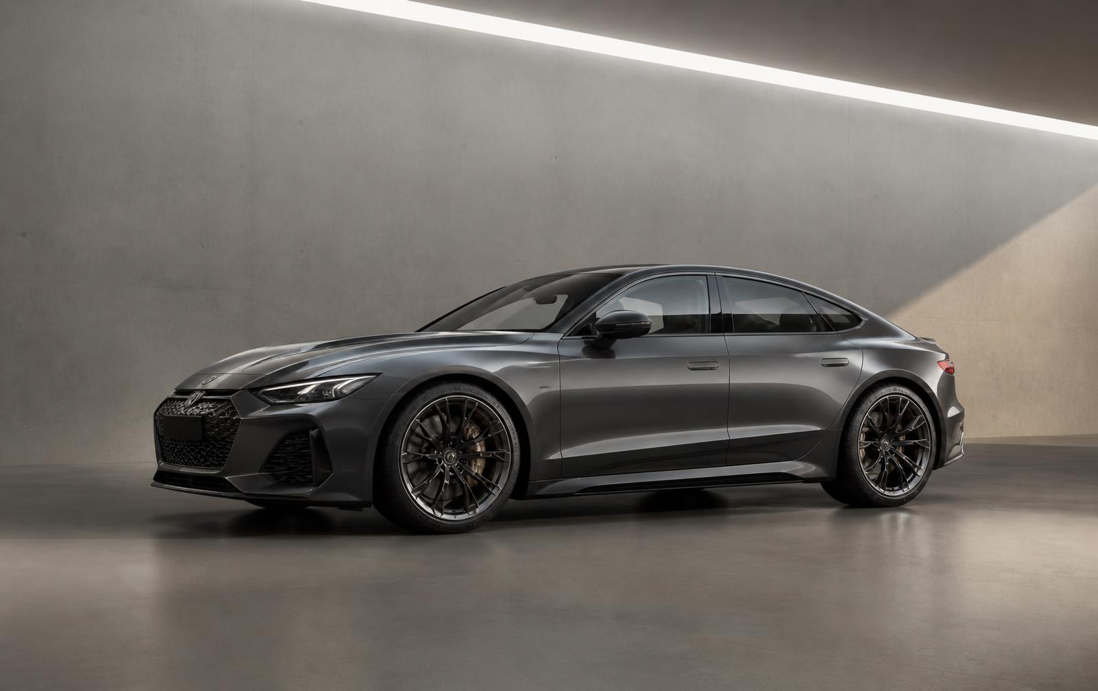 Dark graphite performance sedan lit in a minimal concrete studio